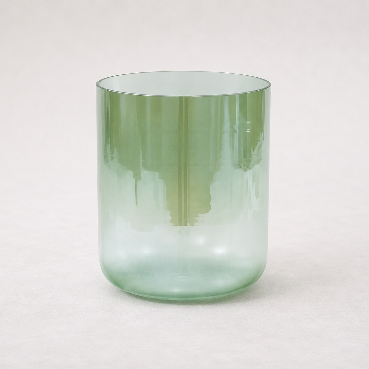 Single translucent sage-green crystal singing bowl with Terratone’s signature earth-inspired gradient finish, photographed on a soft neutral background with a clean minimalist aesthetic.