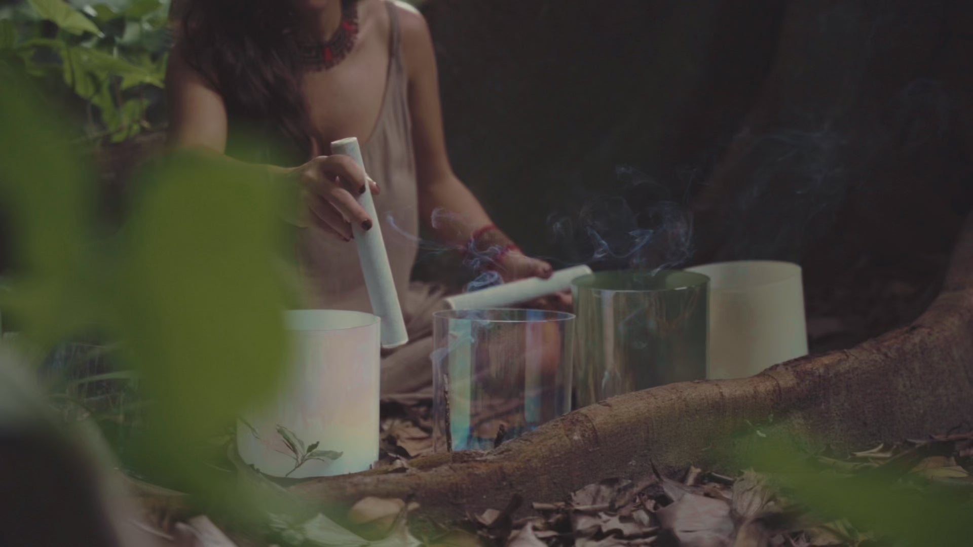 Atmospheric video of crystal singing bowls used in a grounding sound healing ritual in nature.